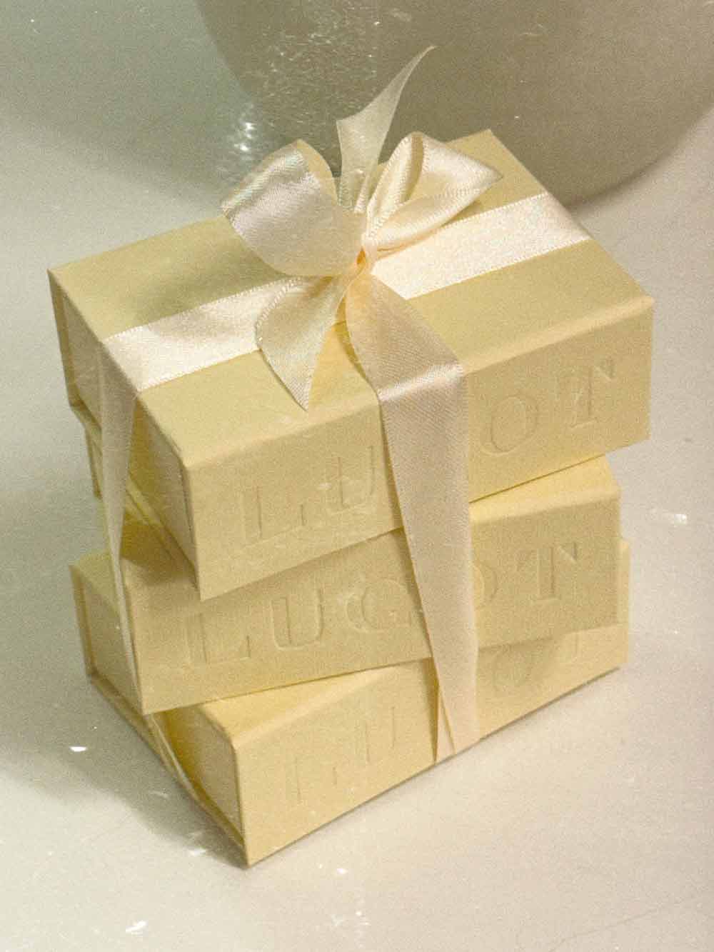 Creamy LUGOT jewellery boxes tied with a ribbon