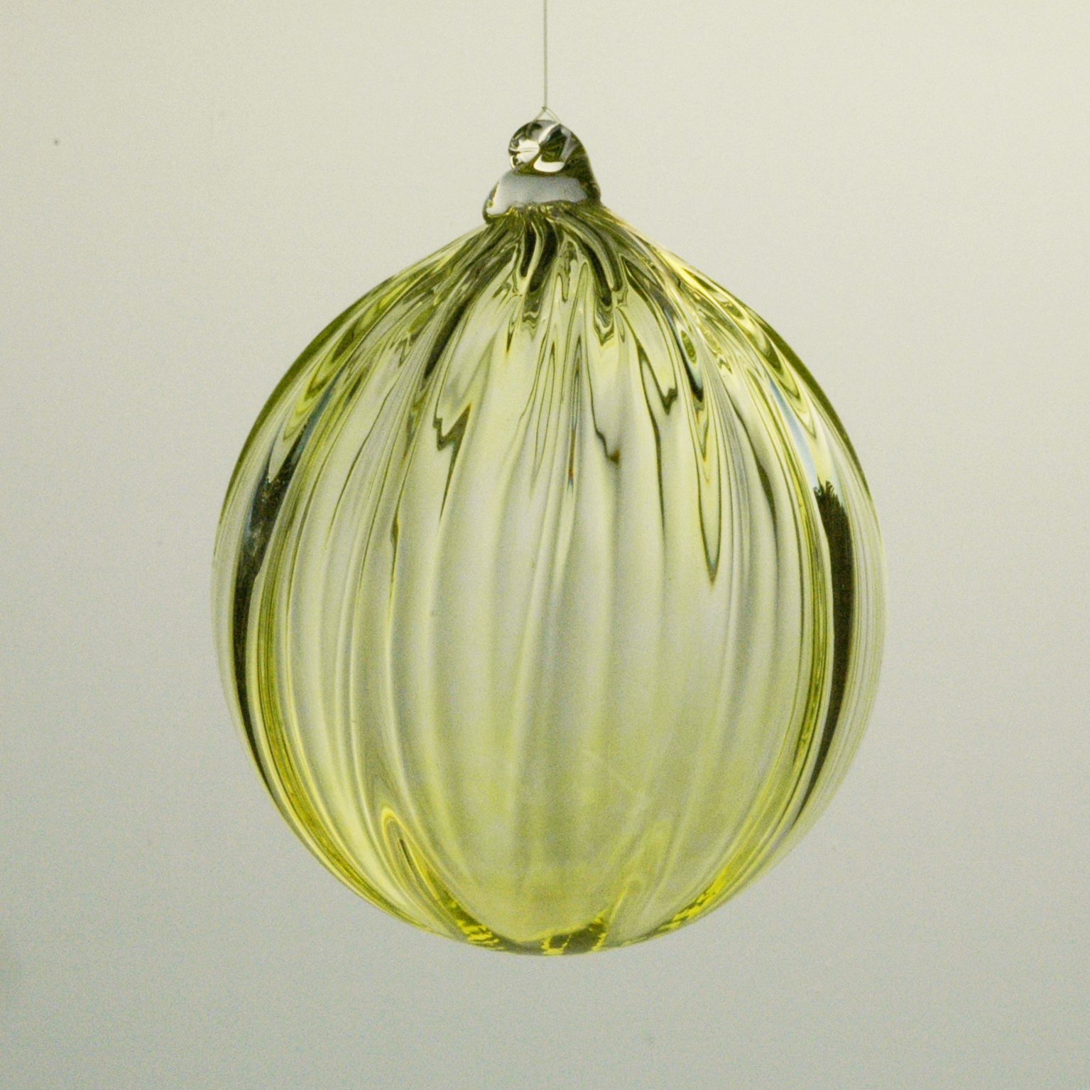 Glass ball, yellowish green.