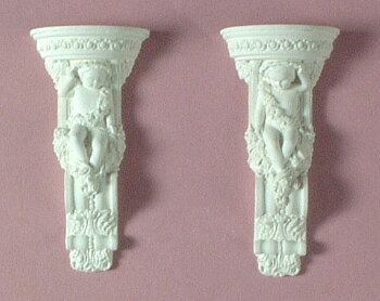 A pair of small cherub brackets - hard casting plaster