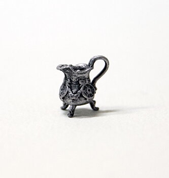 Ornate three legged jug