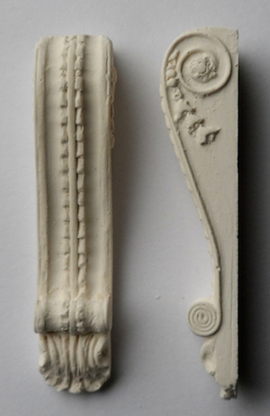 A pair of brackets - hard casting plaster