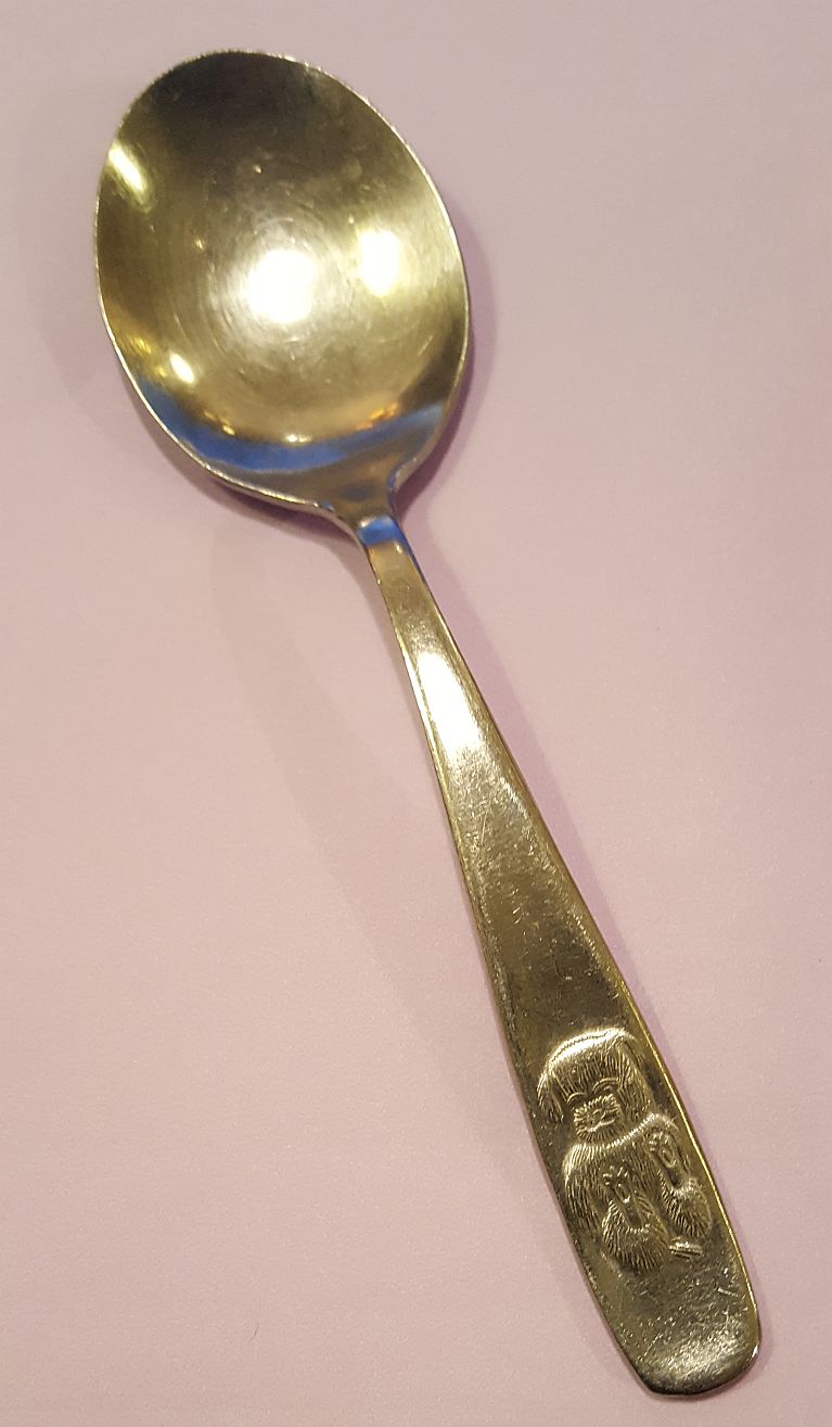 Teddy bear sitting soft fur spoon