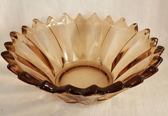 Bowl pinkish-brown with jagged edge