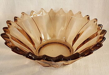 Bowl pinkish-brown with jagged edge
