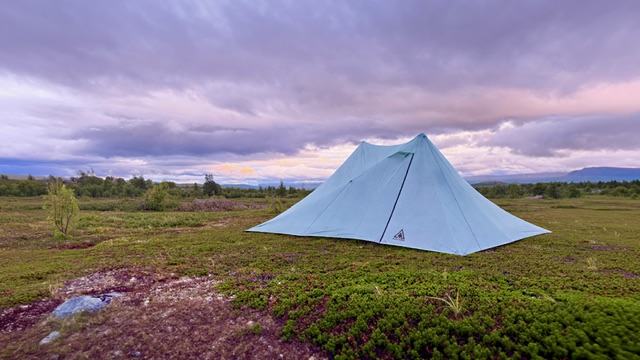 Light blue-grey X-Mid Pro tent pitched on a low fell heath at Fálesjåhkå, just south of the Arctic Circle, under dramatic clouds in evening light
