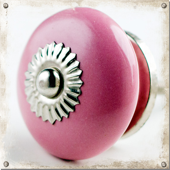 Rund rosa knopp med silverfärgat beslag