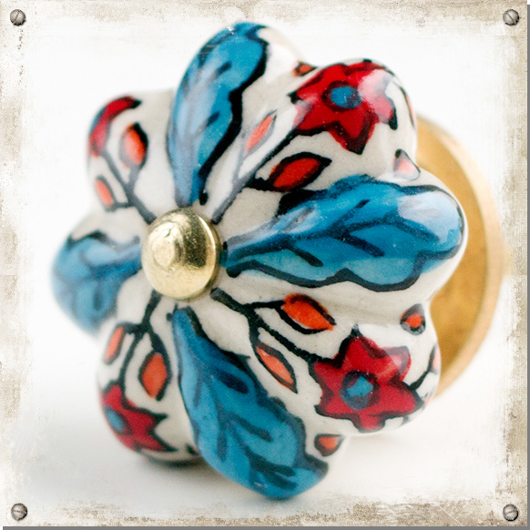 Weißer Knopf mit blauen Blütenblättern und roten Blüten