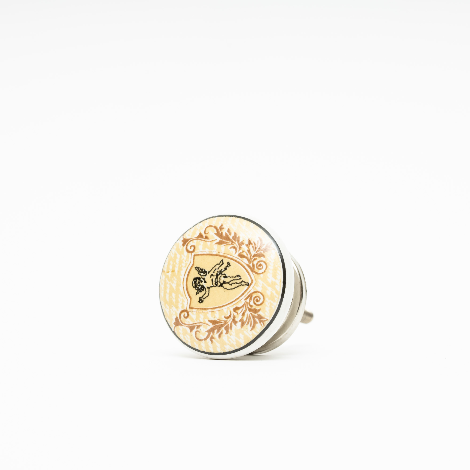 Knopp av porslin i beige med emblem av en ängel