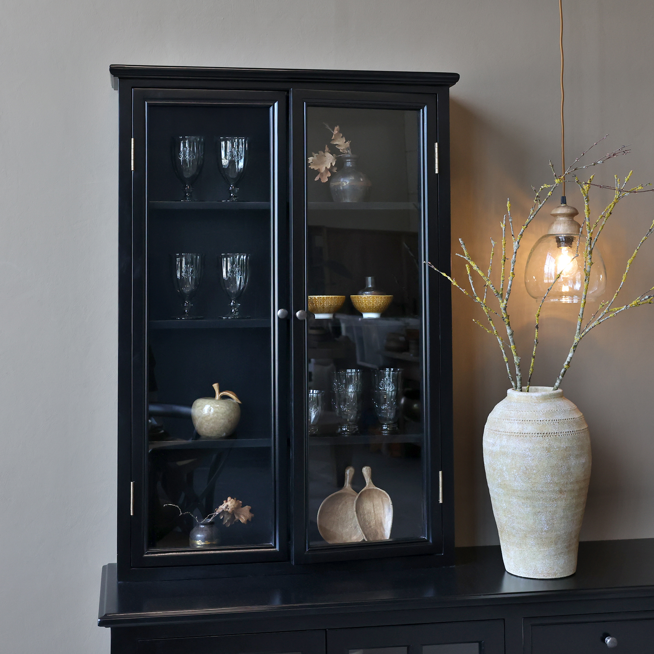 Black rustic display cabinet by Chic Antique with decor items.