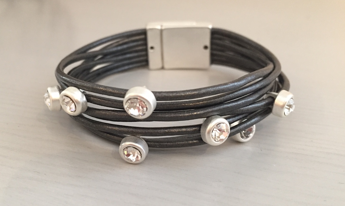 Elisa, Svart armband med 7 st stenprydda läderremmar.