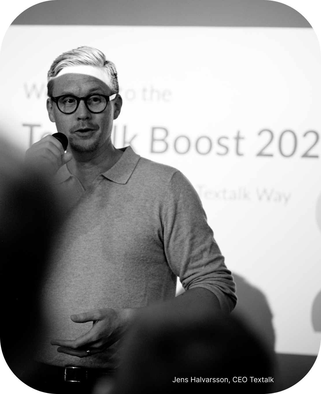 Photo of current CEO Jens Halvarsson speaking into a microphone at Textalk’s annual Boost event for employees.