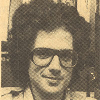 Image shows founder Henryk Rubinstein in the 1970s, smiling with big, curly hair.